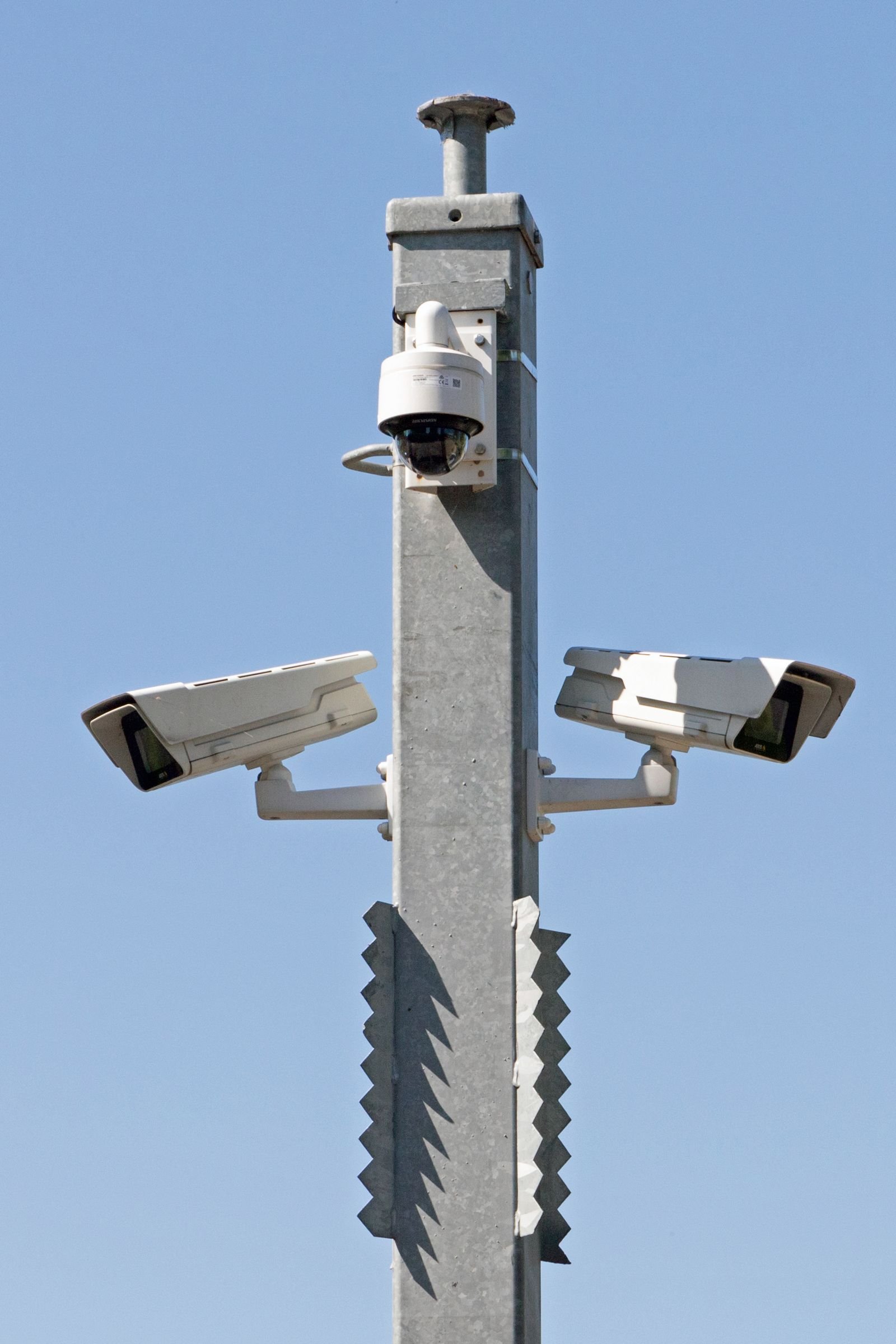 CCTV security cameras mounted on a pole at a site perimeter.