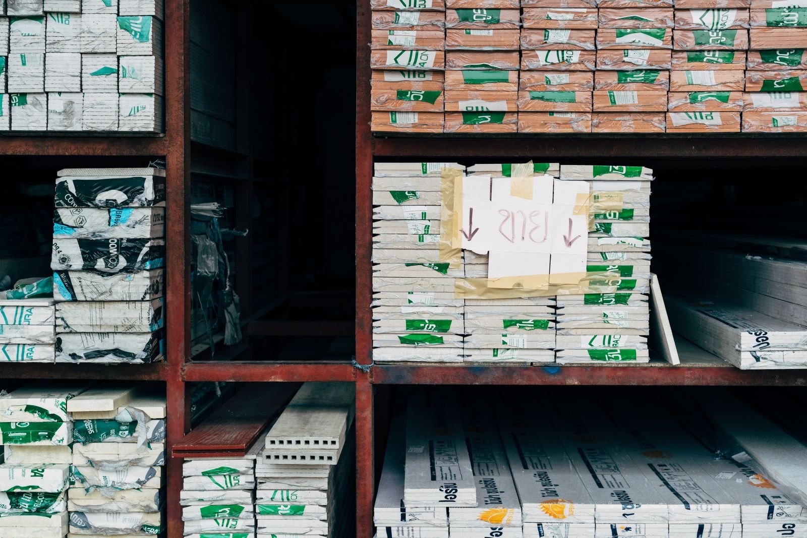 Warehouse interior with organized stacks of building materials.