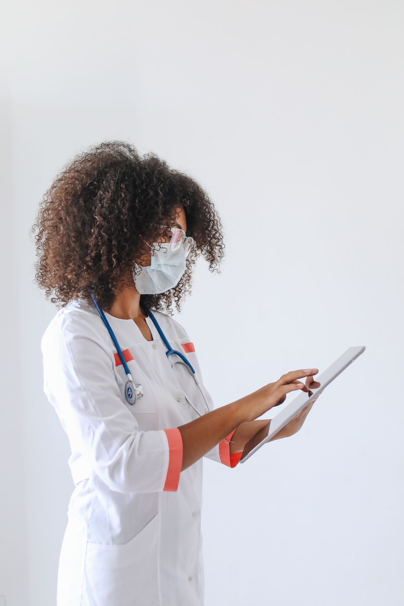 Doctor using a tablet for clinical data entry.