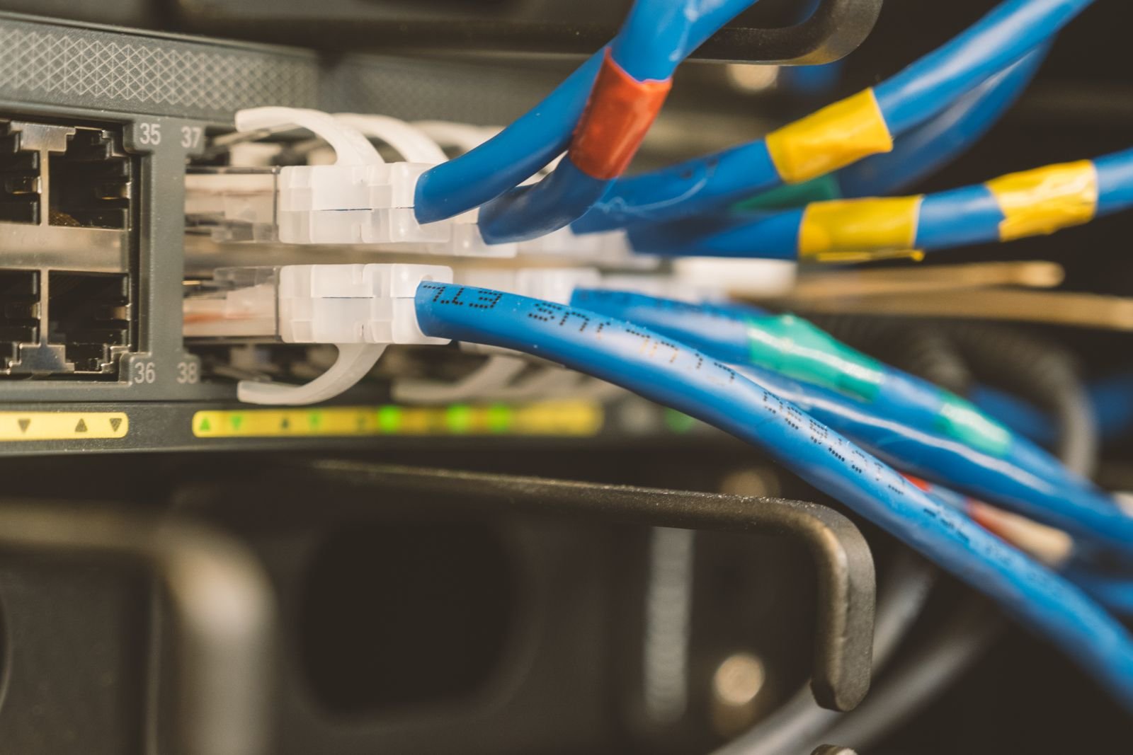 A network switch with an ethernet cable connected to system hardware.