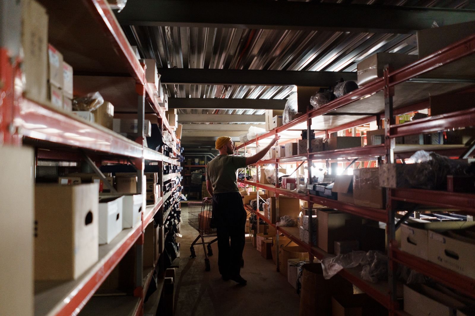 Warehouse shelves stacked with retail and wholesale stock in boxes.